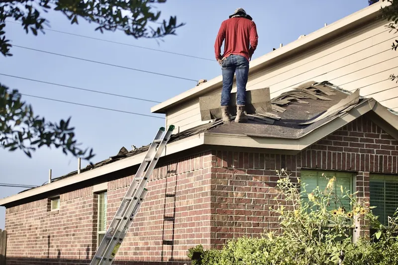 Professional roofer working on a residential roof in St. Thomas